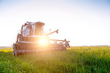 Photo of combine harvester in field at summer.