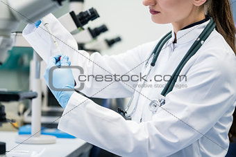Doctor or lab assistant putting solution in blood test at the la