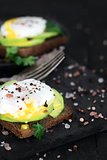 Toasts with avocado and poached eggs background