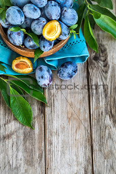 Plums in bowl background
