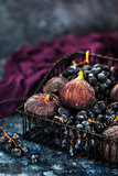 Fresh figs and purple grape in basket