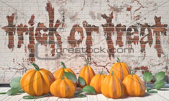 Trick or treat. Halloween greeting with pumpkins and green leafs