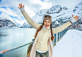 happy traveller woman in winter outdoors rejoicing
