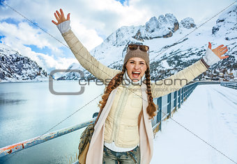 happy traveller woman in winter outdoors rejoicing