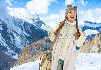 traveller woman in winter outdoors catching snowflakes