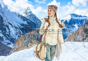 traveller woman against winter mountain landscape looking aside
