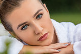 Beautiful Young Woman Relaxing in Robe at Health Spa