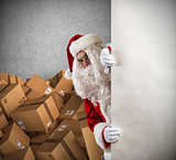 Santa Claus ready to deliver a lot of Christmas presents package