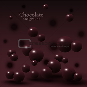 Dark chocolate balls on abstract background.