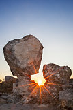Sun rising between megalithic monument, Montanchez, Spain