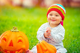 Cute baby playing with pumpkins