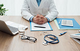 Doctor working at office desk