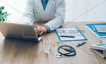 Doctor working with a laptop