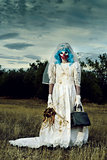 scary evil clown in a bride dress outdoors