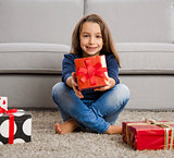 Little girl opening presents