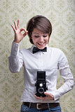 happy vintage photographer showing an OK sign