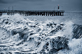 View of the pier at stormy evening time.