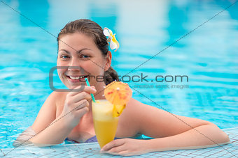 woman 30 years in the pool enjoying relaxation and cocktail