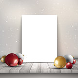 Blank canvas on wooden table with Christmas baubles