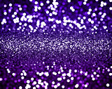 Christmas background with purple glitter and bokeh lights