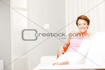 Happy confident woman relaxing on a couch