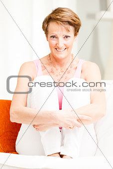 Attractive stylish mature woman relaxing at home