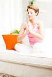 Attractive woman practicing yoga at home