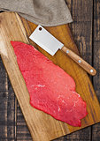 Fresh raw beef steak in black on wooden board