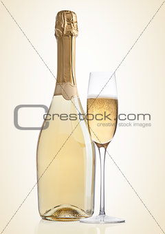 Bottle and glass of yellow champagne on yellow 