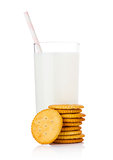 Glass of milk with round cheese crackers on white