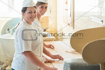 Baker women working in bakehouse of bakery