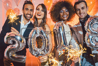 Group of party people celebrating the arrival of 2018