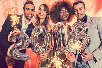Men and women celebrating the new year 2018