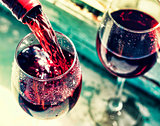 pouring red wine. Wine in a glass, selective focus, motion blur,