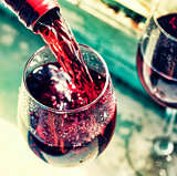 pouring red wine. Wine in a glass, selective focus, motion blur,