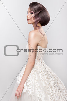 Beautiful bride with fashion wedding hairstyle - on white background.