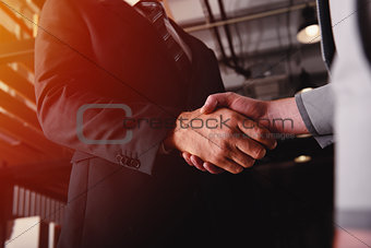Handshaking business person in office. concept of teamwork and partnership