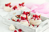 Delicious mini Pavlova meringue cake decorated with fresh raspbe