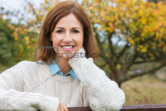 Attractive Happy Middle Aged Woman Resting on Fence
