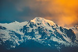 Sunset evening view over the snowy mountain peak