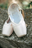 Pointe shoes for a classical ballerina, close-up on concrete