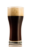 Dark beer in a glass, isolated on a white background