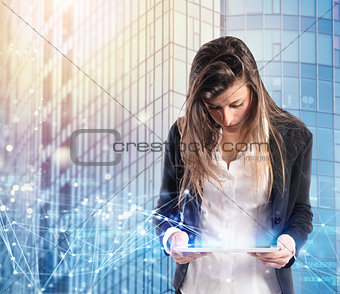 Businesswoman in office connected on internet network with a tablet