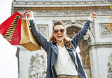 smiling woman with shopping bags in Paris, France rejoicing
