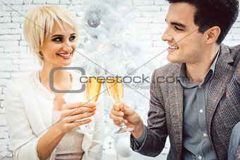 Couple clinking with sparkling wine for Christmas
