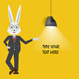 Rabbit teacher showing with empty place for your text or design. Lamp hanging on yellow background.