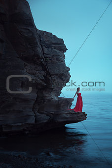 A sad woman near the sea in evening