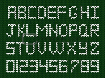 Fabric script on deep green knitted background.