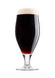 Cold glass of dark beer with foam and dew