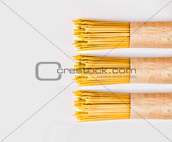 Spaghetti packed into paper on a white background. Supermarket.